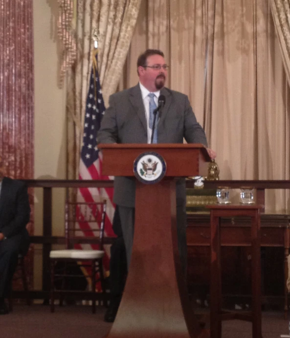 a man stands in front of a podium