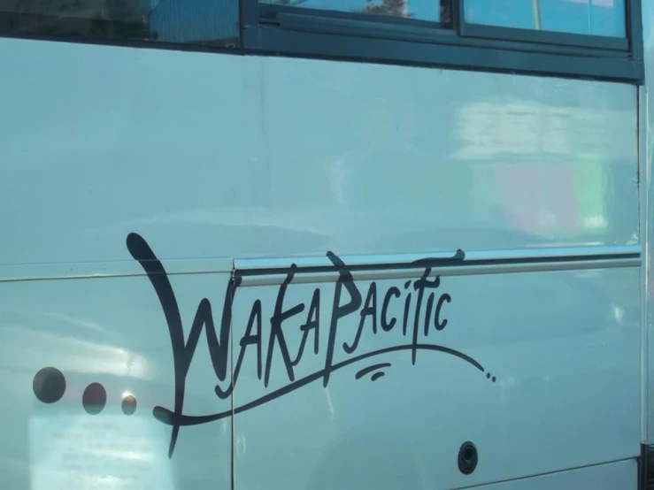 graffiti on the side of a bus reading waka pacific