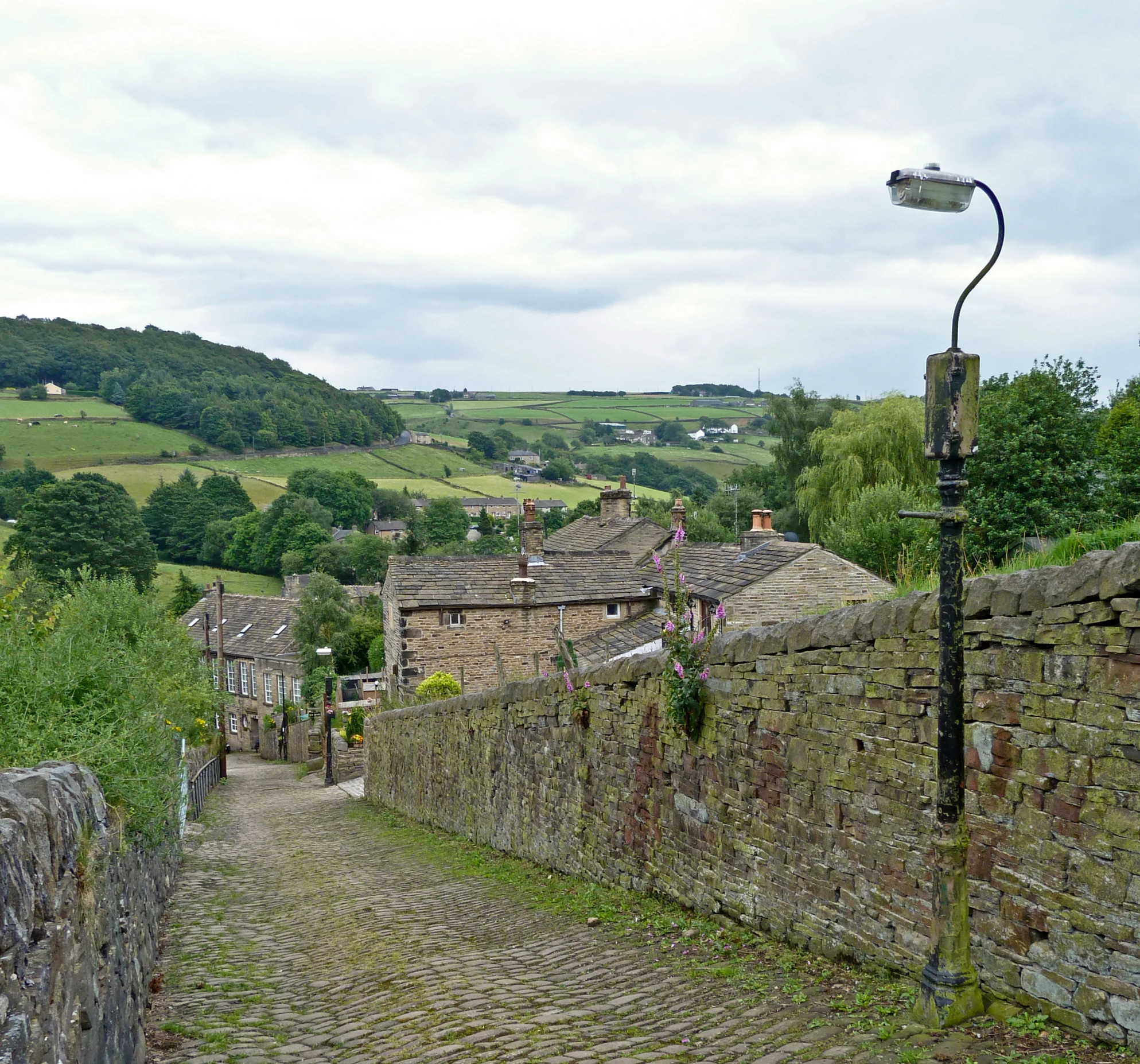 a cobble stone road lined with old brick buildings