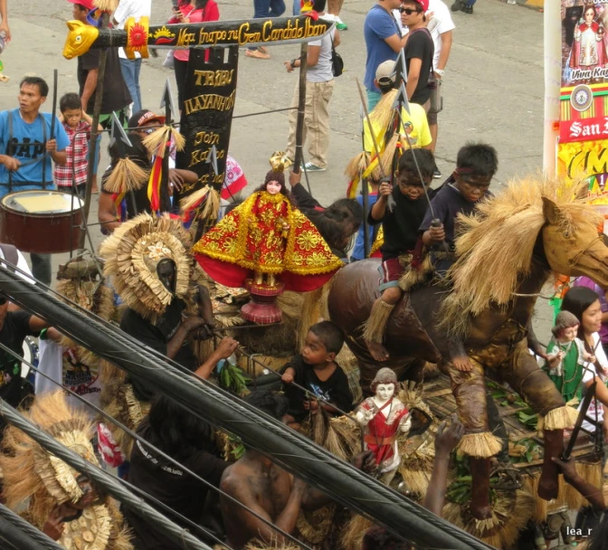 a group of people in elaborate costumes are dancing with a horse