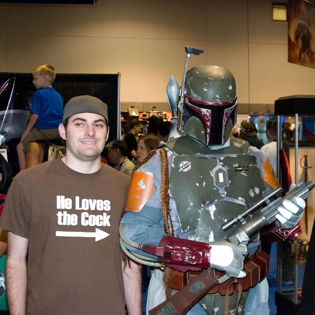 a man posing with his costumed friend in an office