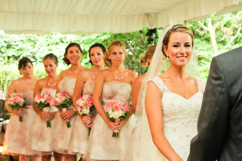 a young bride and groom smiling at each other