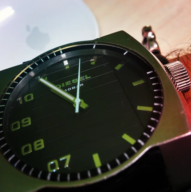 the watch is green and black with numbers on it