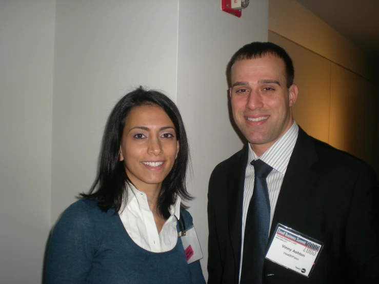 a man and woman in formal wear pose for the camera