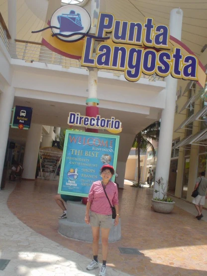 a person standing underneath the sign for punta langbosta