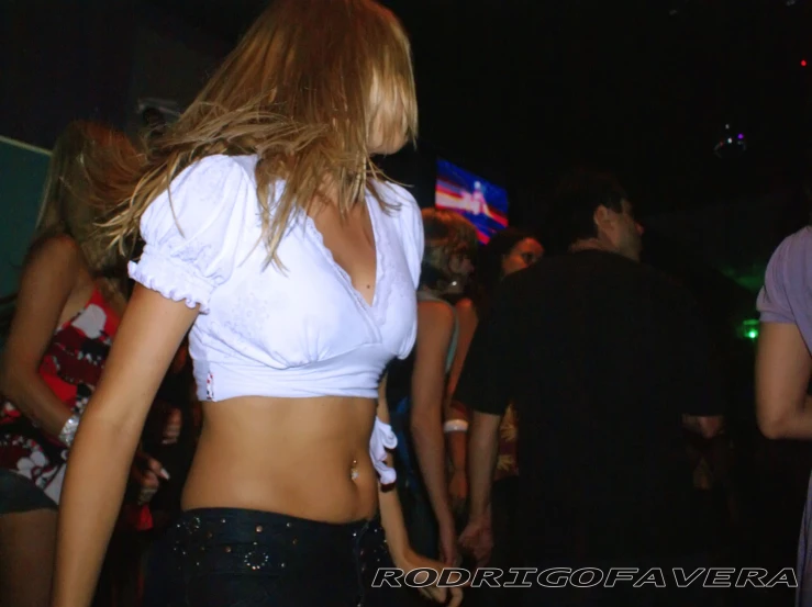 a person in a bikini top and shorts at a club