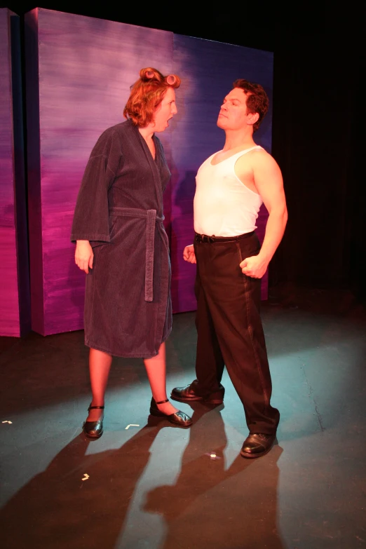 a man and woman standing near each other on a stage