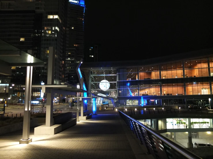 a walkway in a city next to some tall buildings