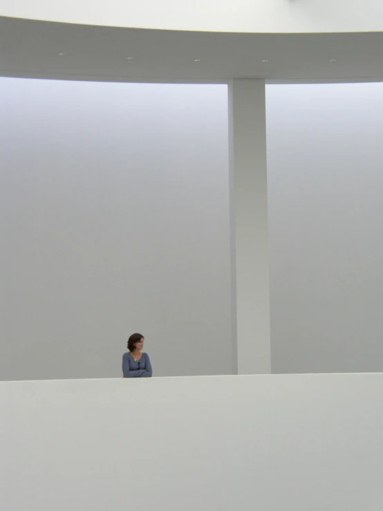 two women standing at the edge of a room looking around