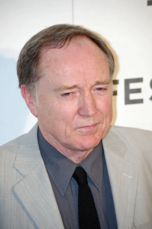 a man in a suit and tie posing for the camera