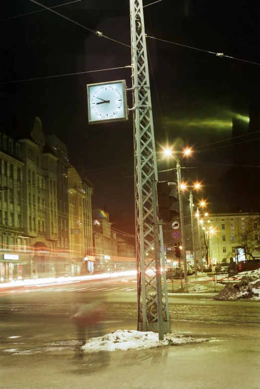 city street with many traffic lights and buildings