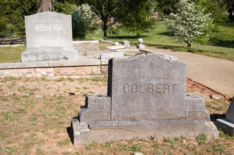 some headstones on the ground near a road