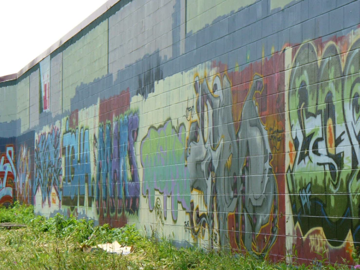 a large colorful graffiti wall that is on the side of a building