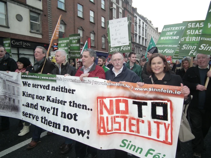 people protesting in a protest on the street with green and red flags