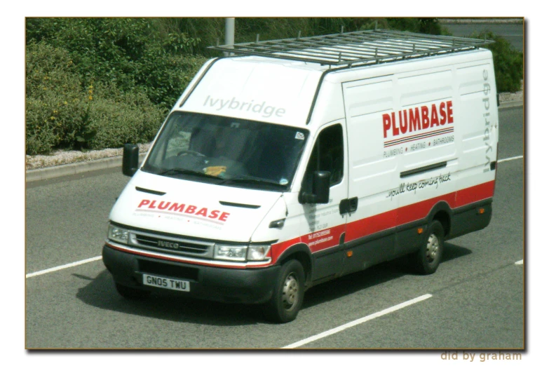 a plumbbase delivery truck driving down the street