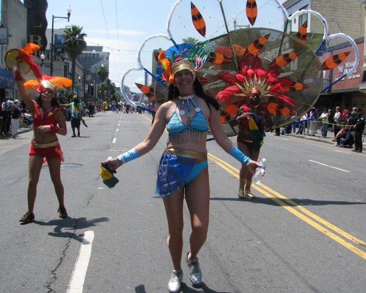 two women are on a city street, dressed in costumes