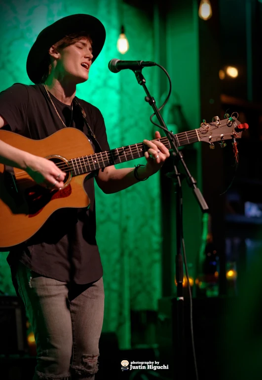 a person is playing a guitar on the stage