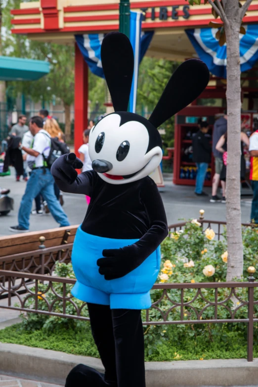 a man in a costume on the sidewalk of a street