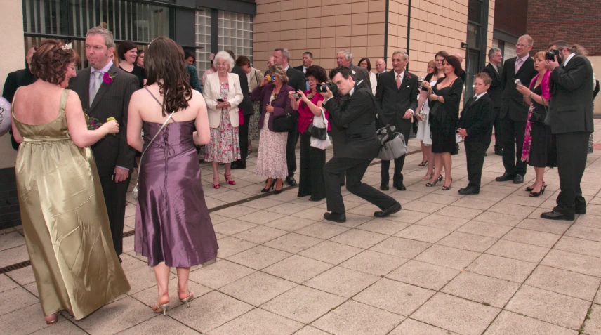 several people dressed up in formal wear dance on pavement