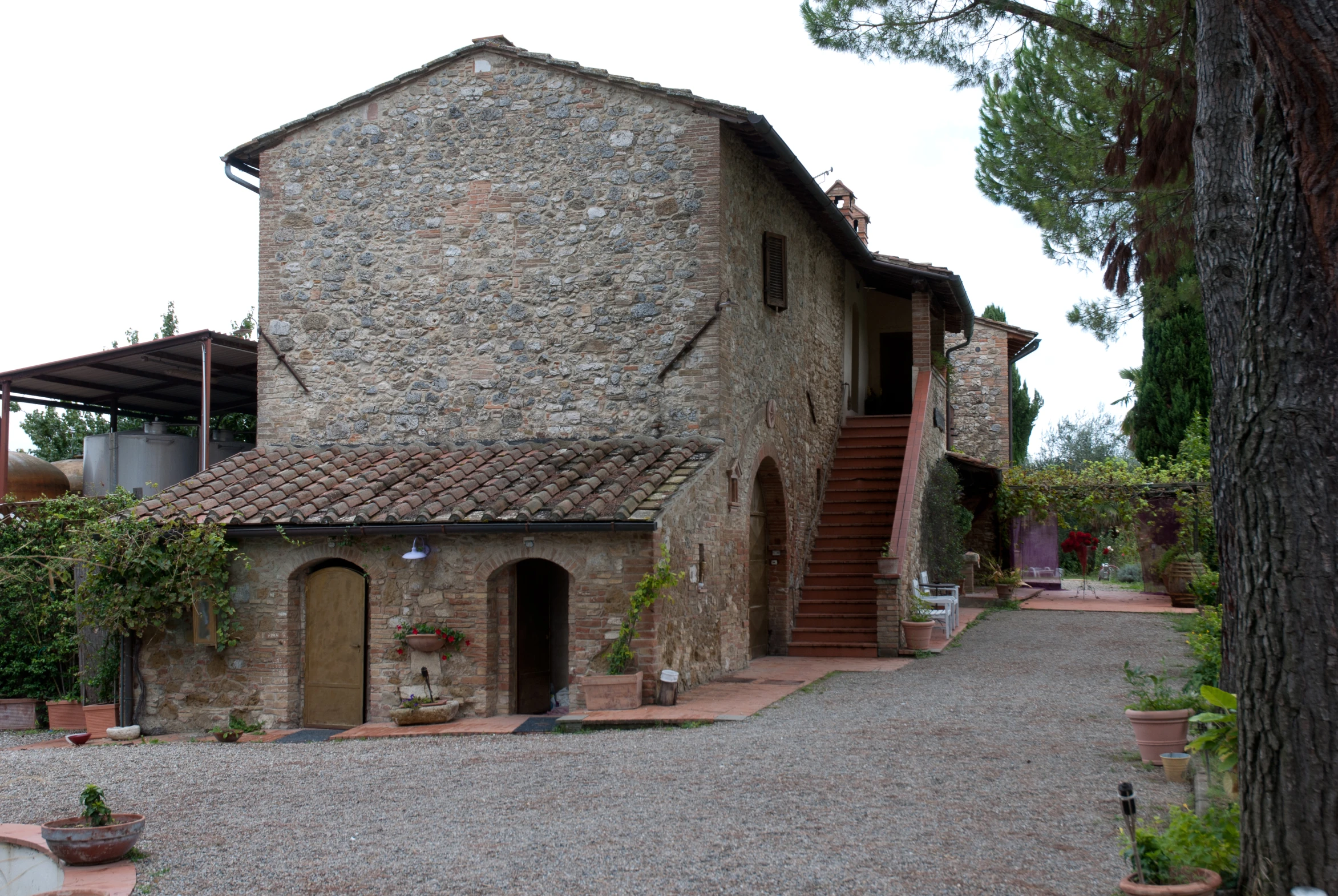 a stone building sitting next to a tree