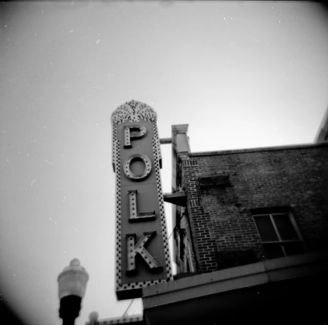 a black and white po of the neon sign of a theater