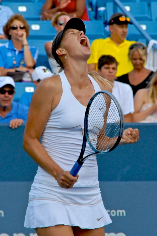 a woman is screaming while playing tennis