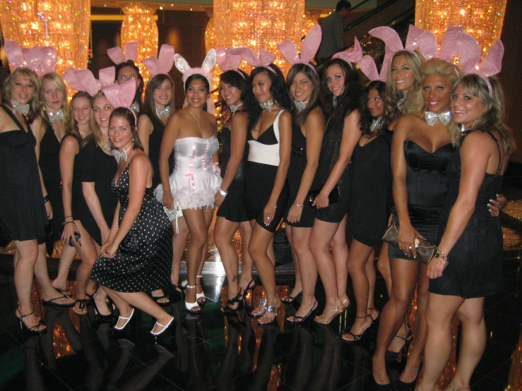 a large group of beautiful women in black and white dresses