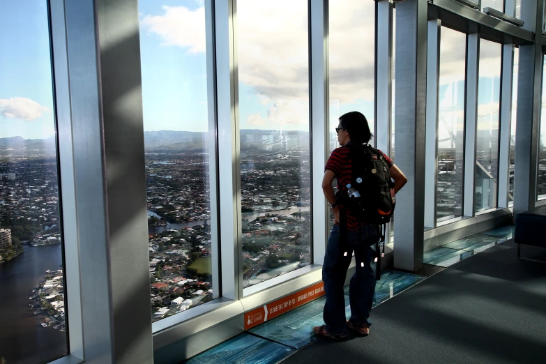 a woman looking out the window at a city