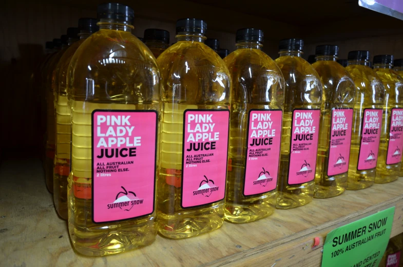 the bottles on display have pink labels on them