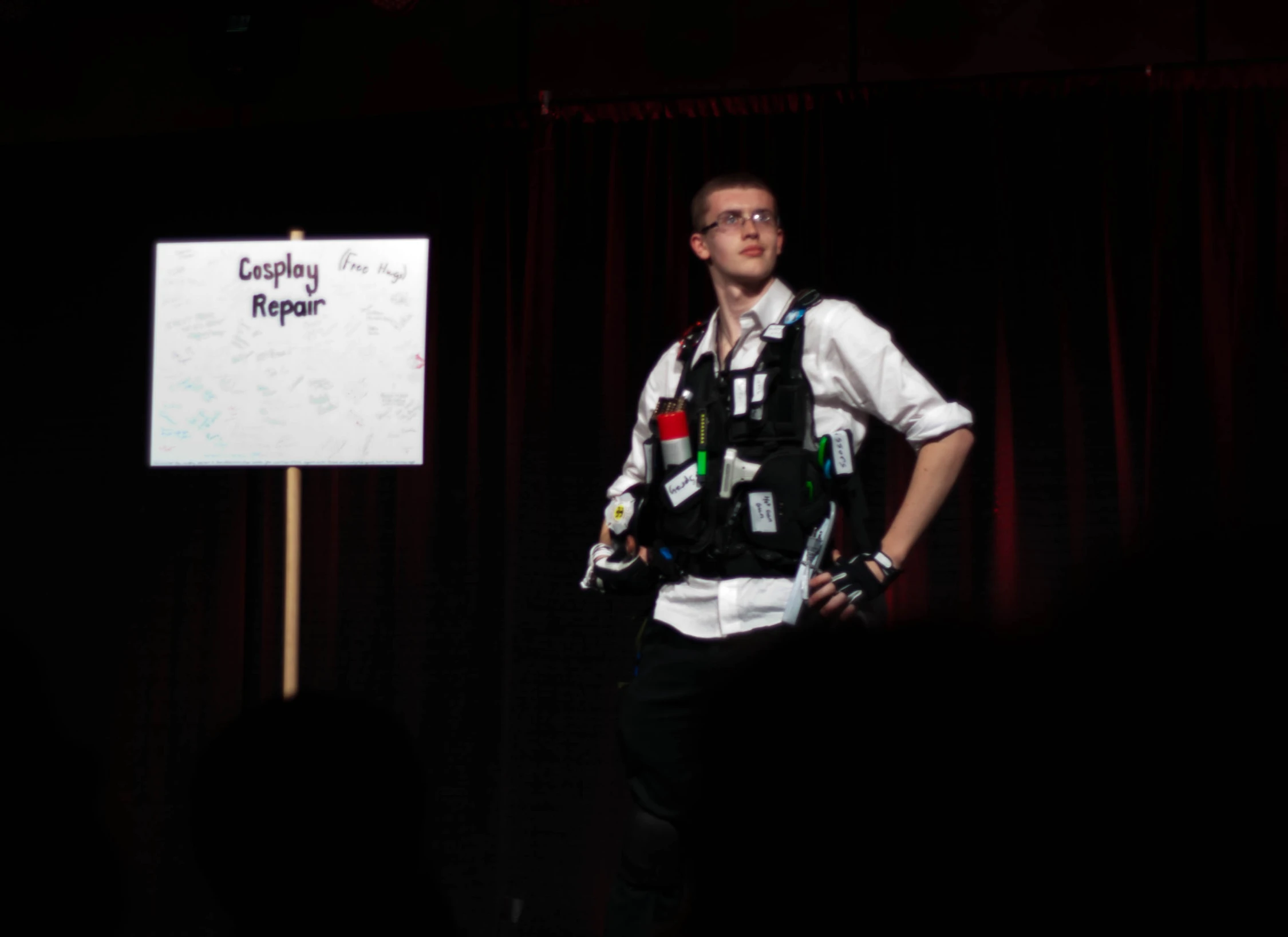 the man stands in front of a sign with writing on it