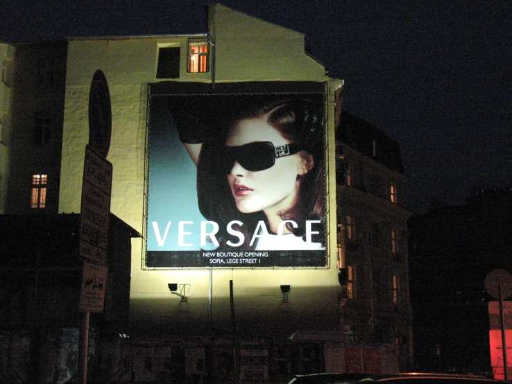 a lit advertit on a building in the evening