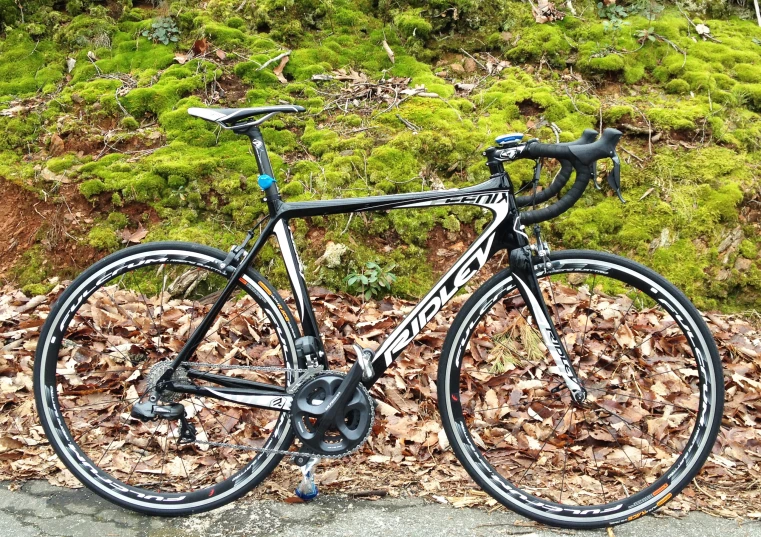 a black and silver bicycle parked on top of a street