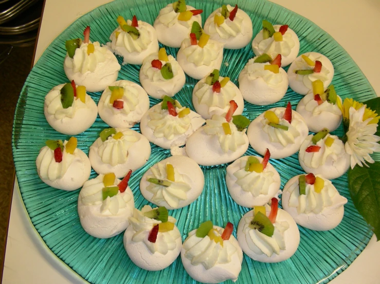 an elaborate plate of cakes that are decorated with white icing