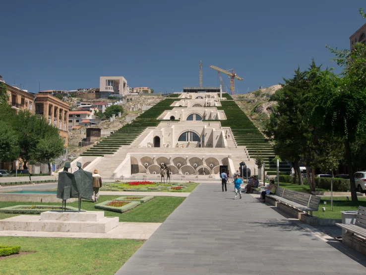 people walking in front of a structure of steps