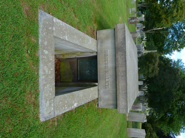 grave entrance, with door open in a green cemetery