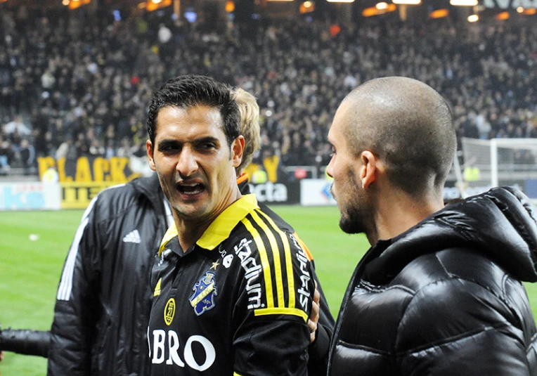 two men on the field talking to one another