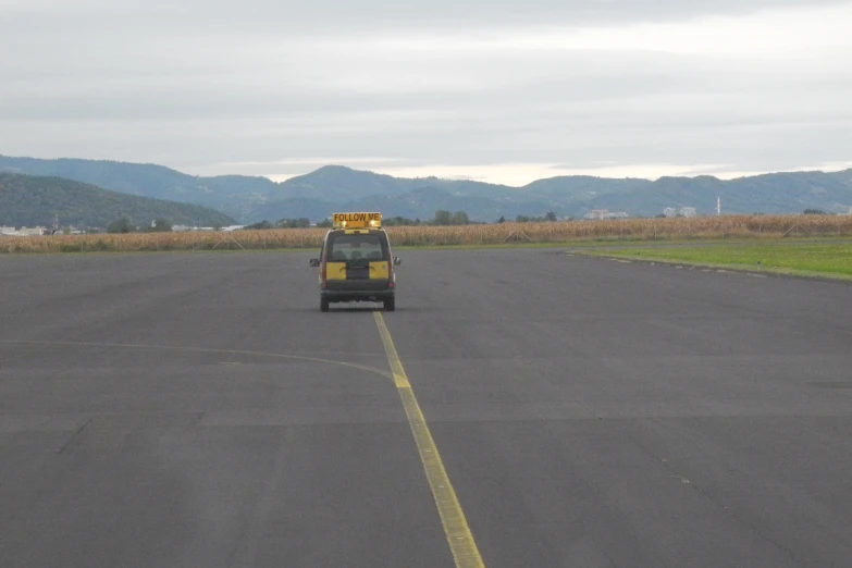 the bus is going down the empty runway