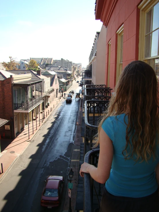 a woman looks down an empty city street