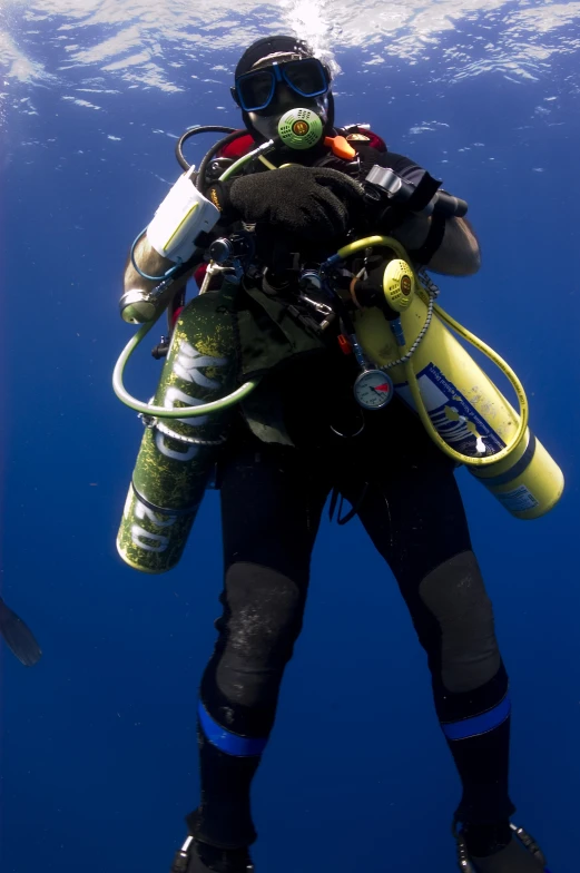 a person is dressed in scuba gear and is diving in the water