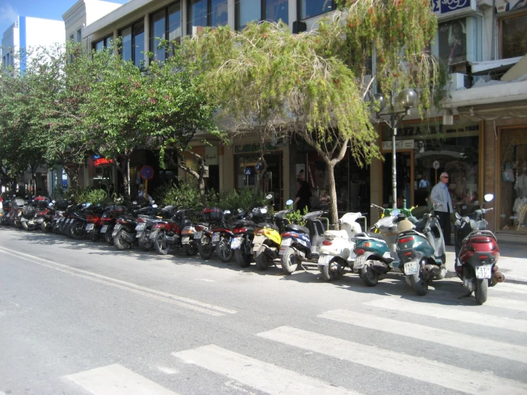 a large group of motorcycles parked on the street