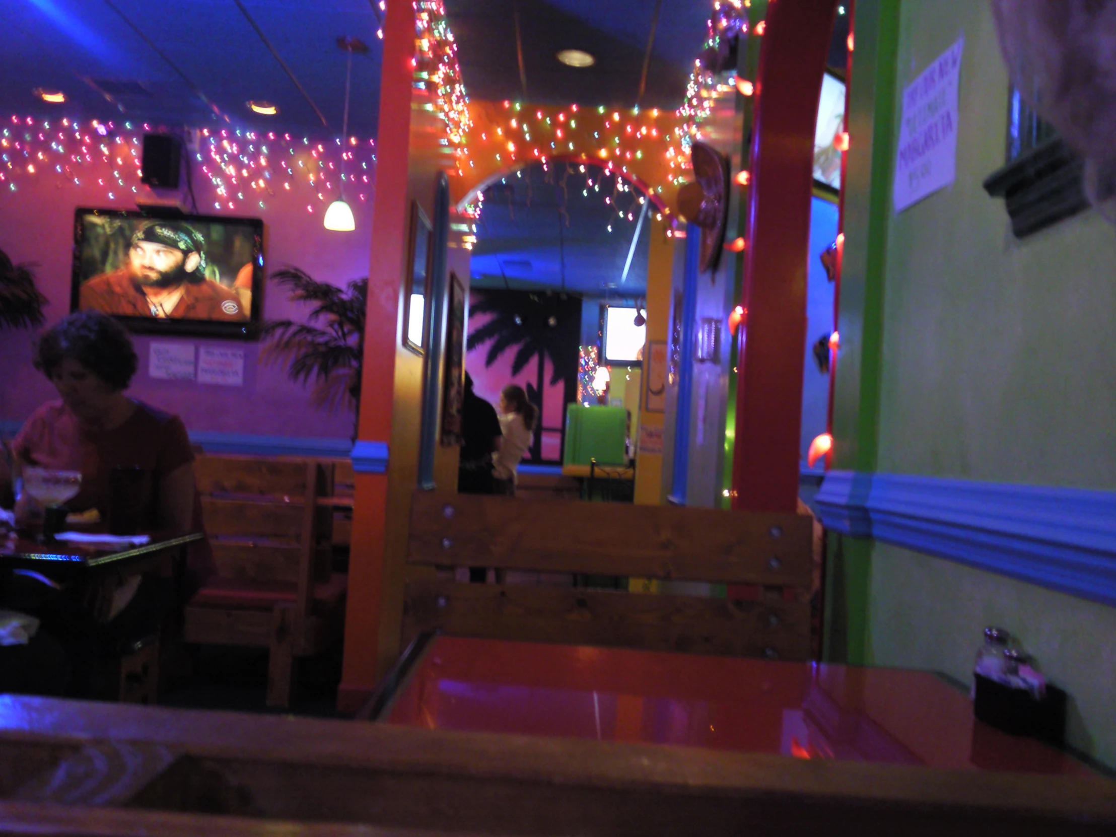 a person sitting at a booth in a restaurant