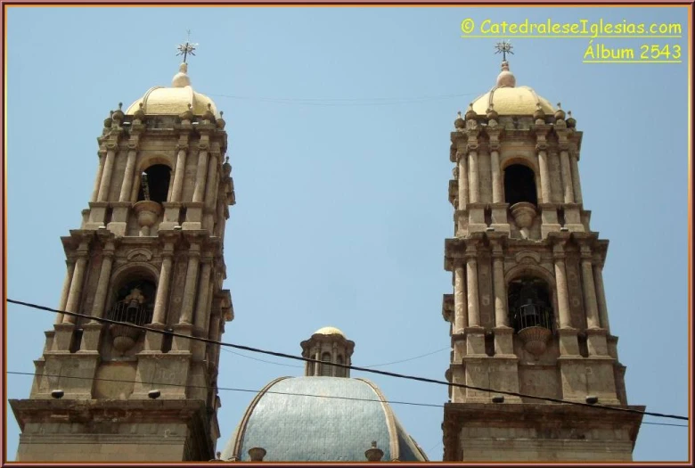 a view of some church spires in the blue sky