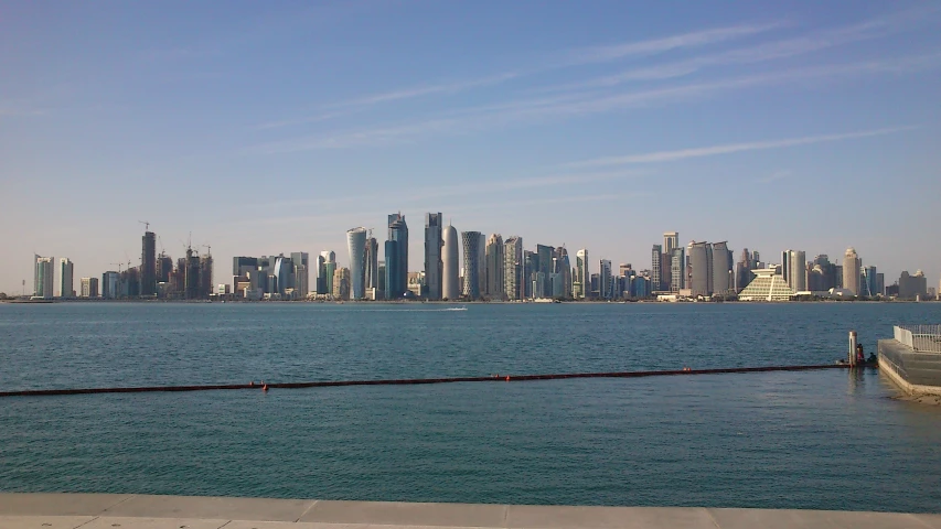 a boat in a harbor near a large city