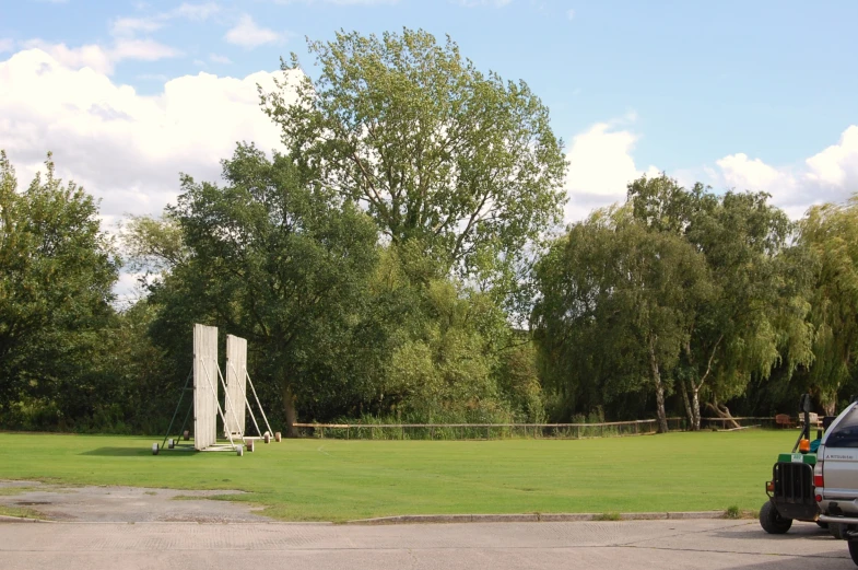 a large, white structure in a field of green grass