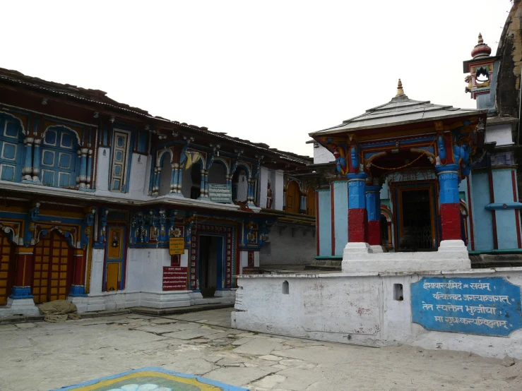 a colorful building with statues in the courtyard