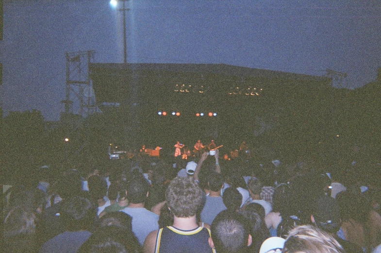 a crowd of people standing around at a concert