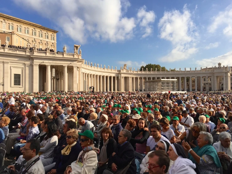 large crowd of people gathered in front of a building