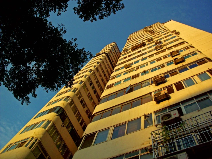 the side of a tall building next to trees