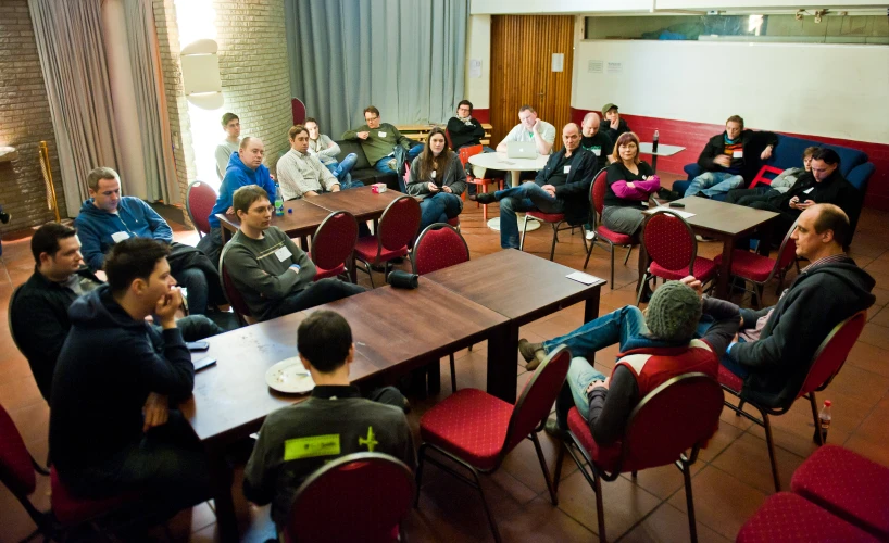 a group of people sitting in chairs at a table