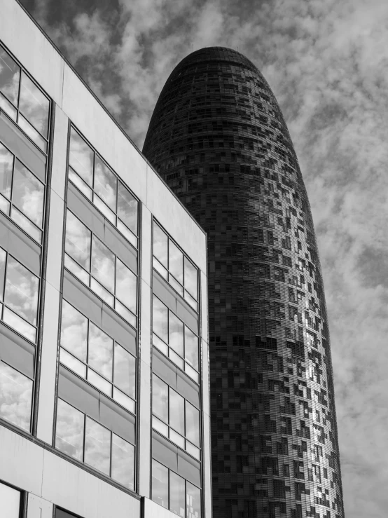 a tall black building near a cloudy blue sky